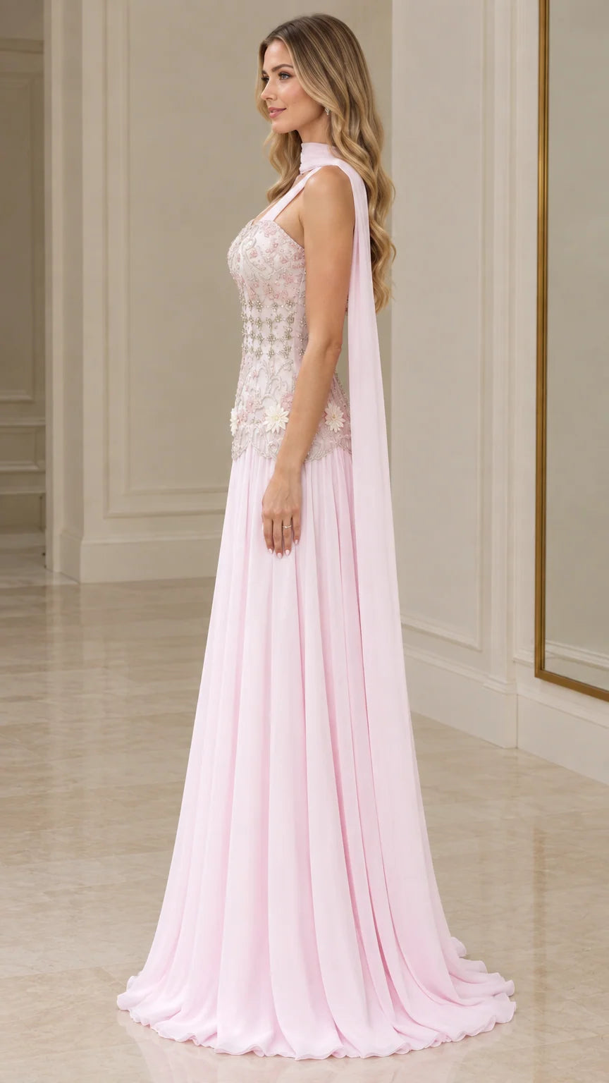Side profile of blush pink A-line formal gown with flowing chiffon cape