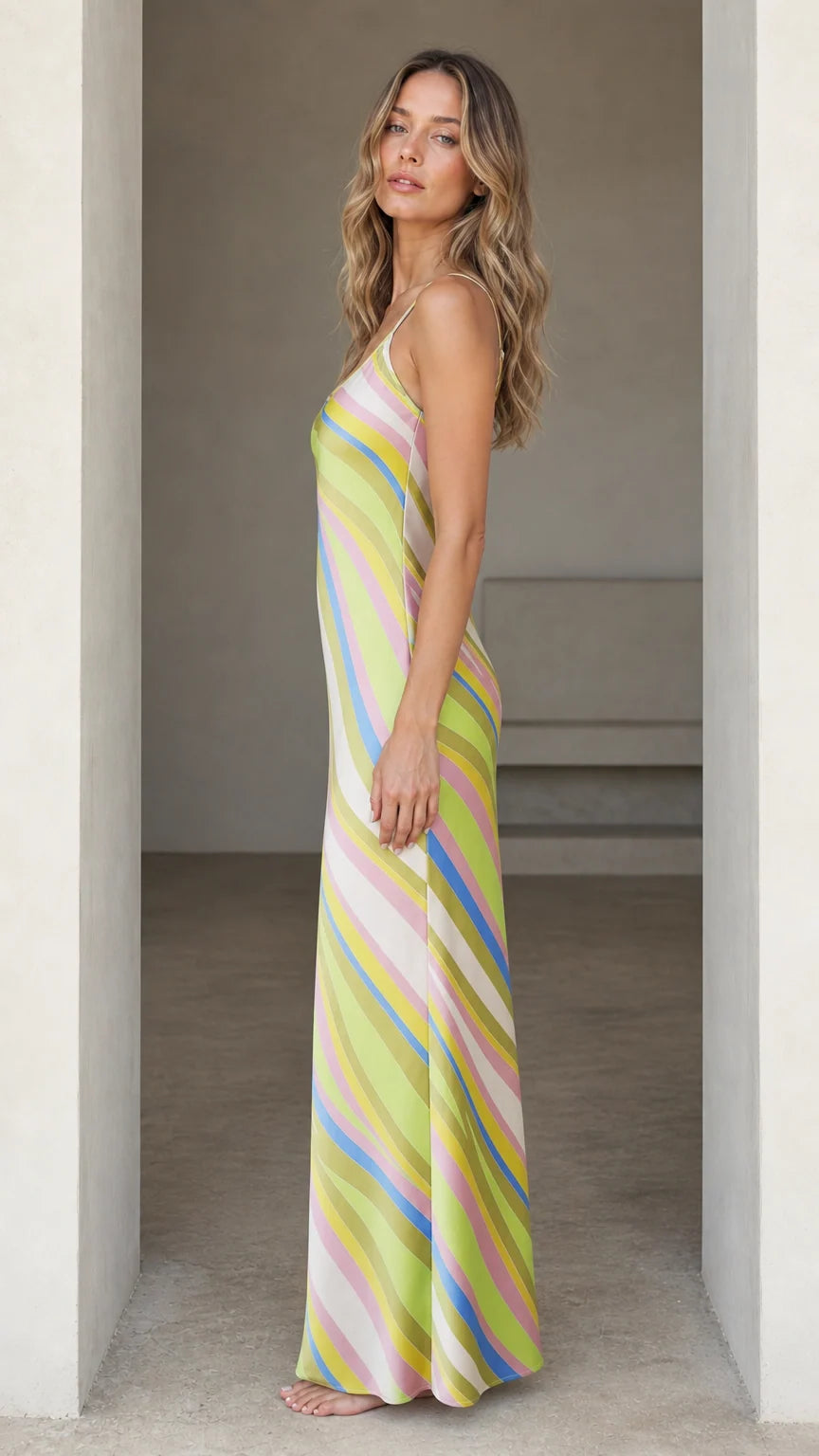 Side profile of woman wearing Lime Multi striped maxi slip dress