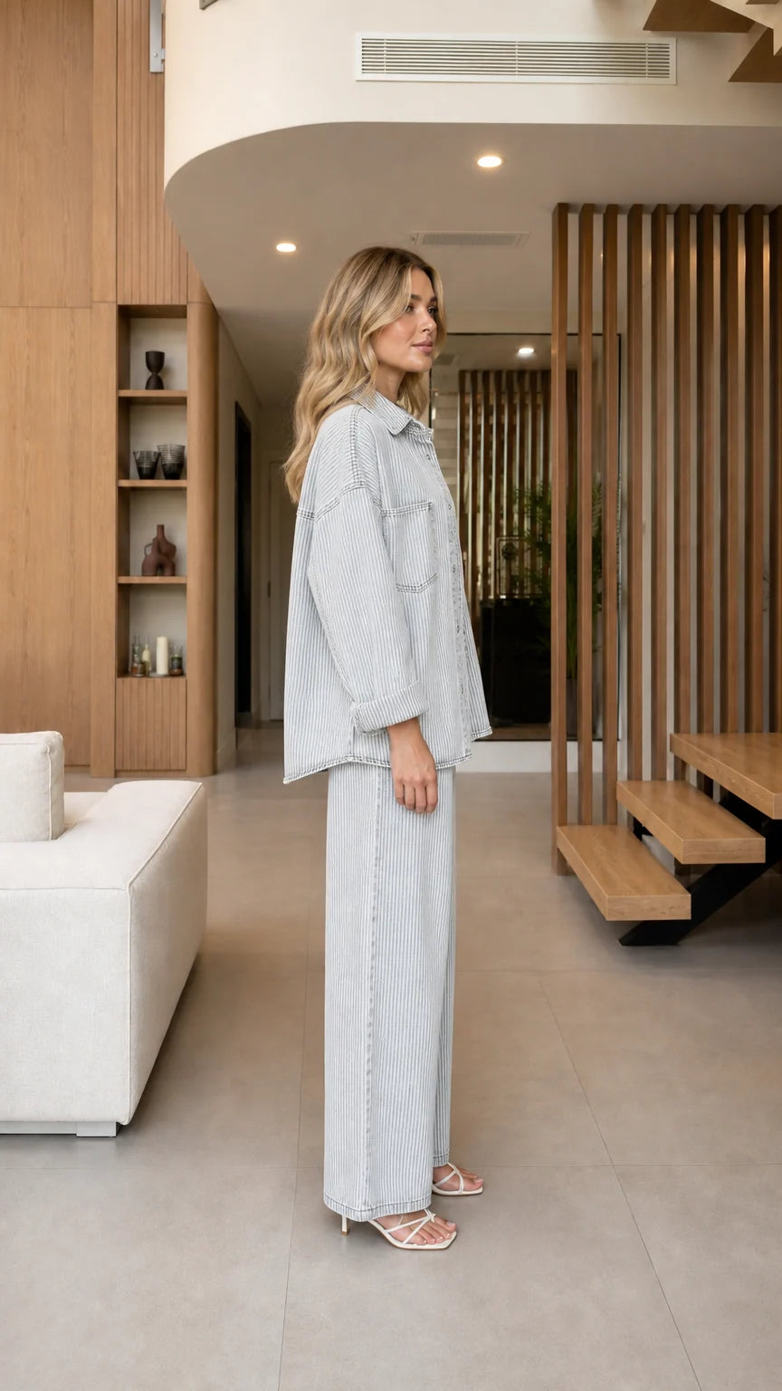 Side profile view of model wearing Light Blue striped two-piece denim set