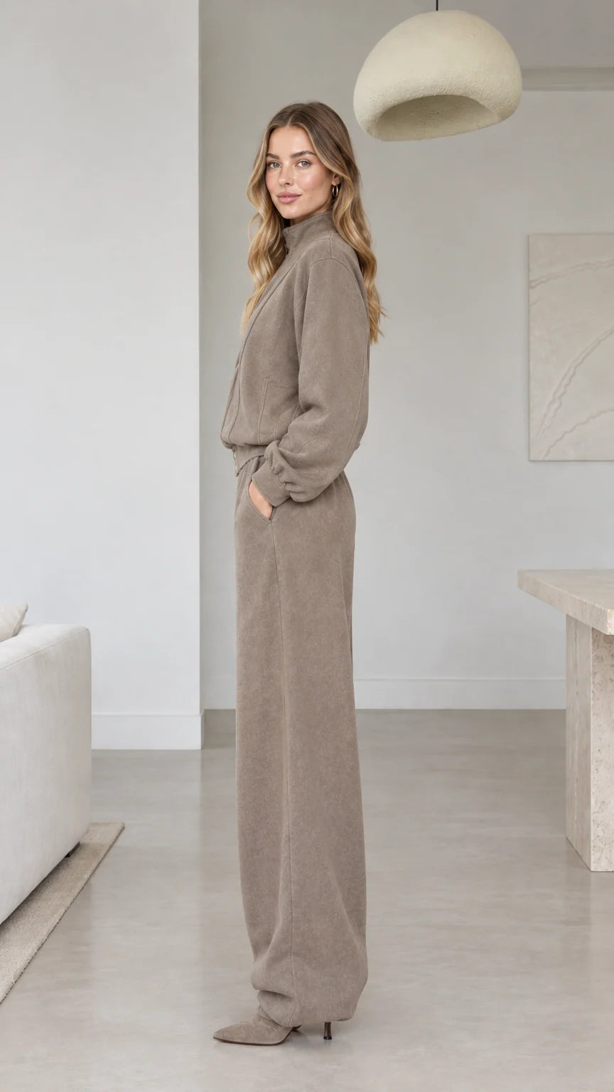 Side view of woman wearing taupe wide-leg casual two-piece tracksuit