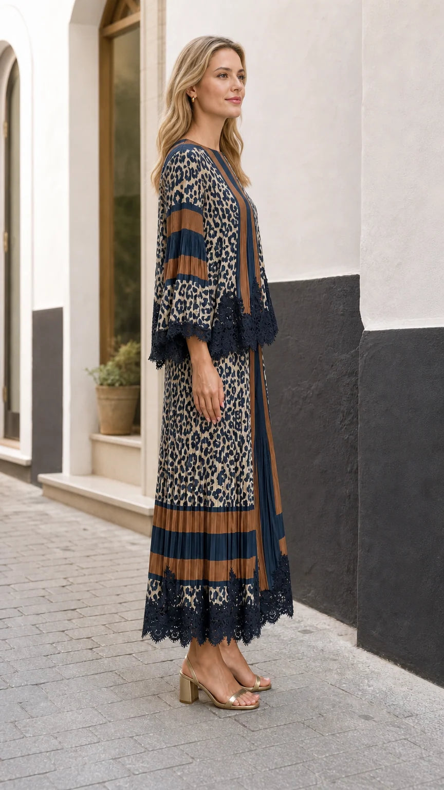 Side angle view of model showcasing the flowing wide-leg silhouette of the navy blue pleated set
