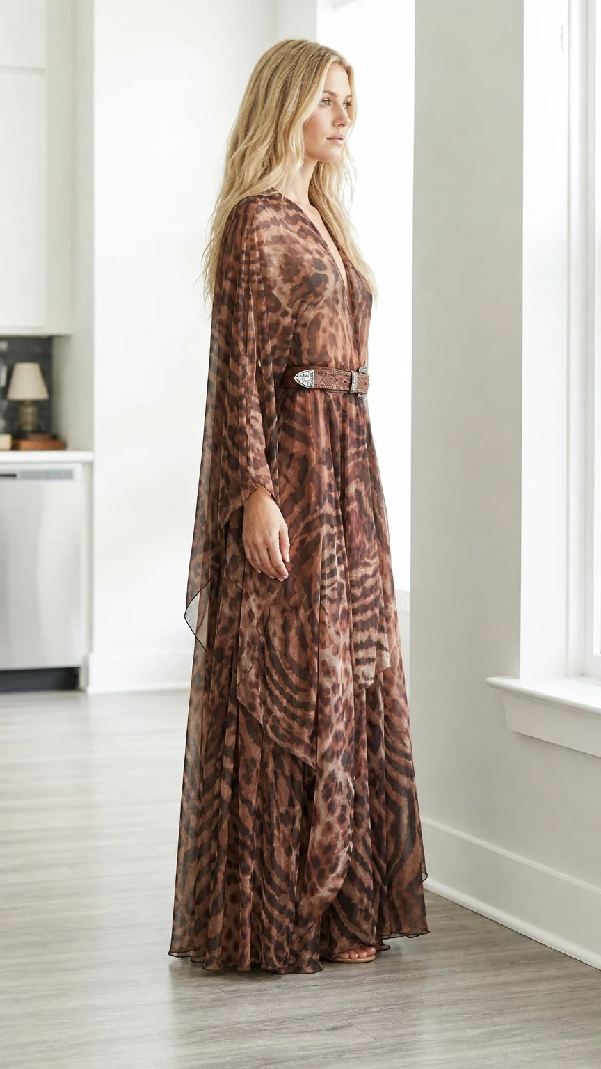 Side-angled view of brown flowing chiffon animal print maxi gown