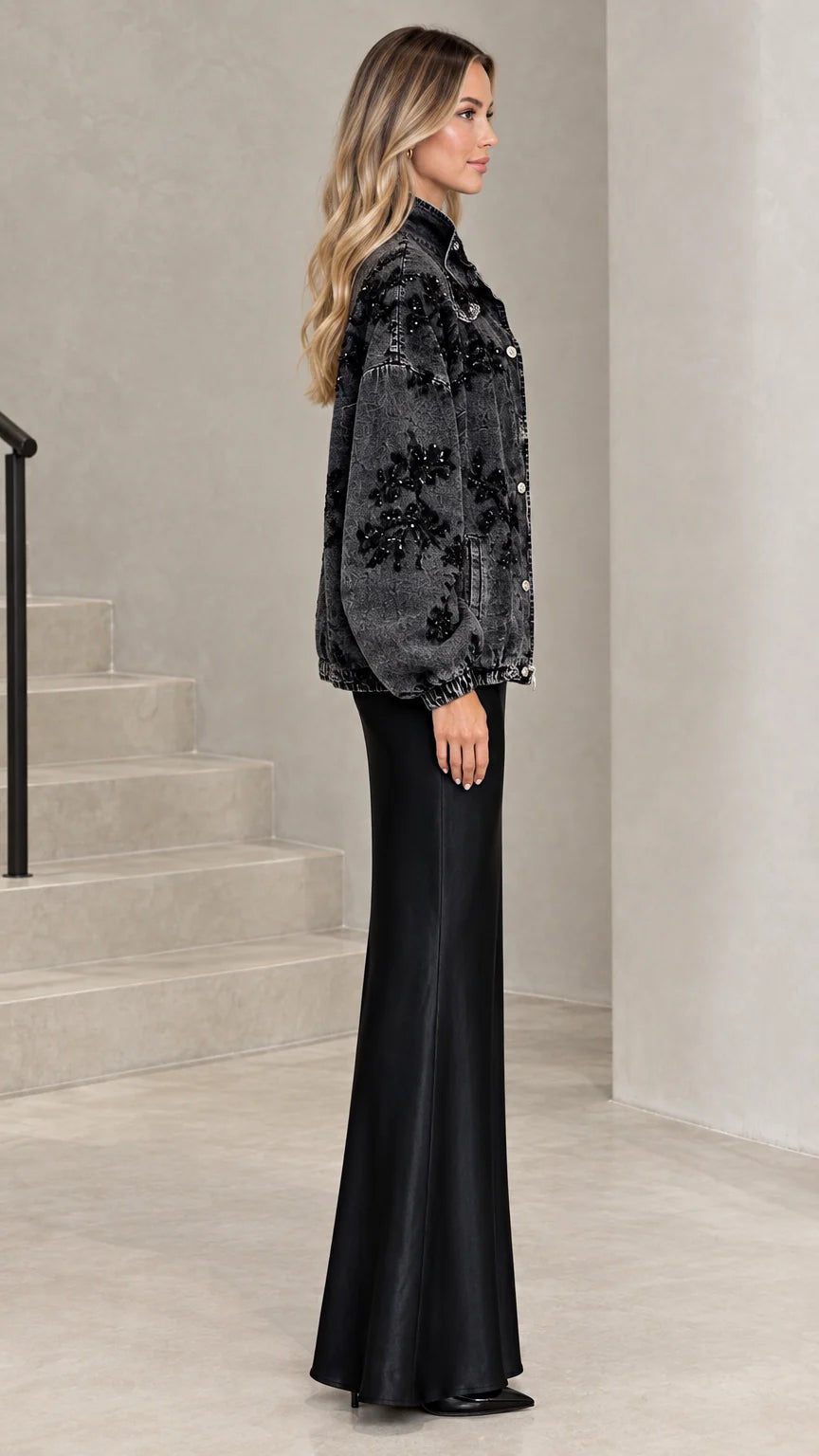 Side profile of washed black sequin denim jacket showing voluminous sleeves