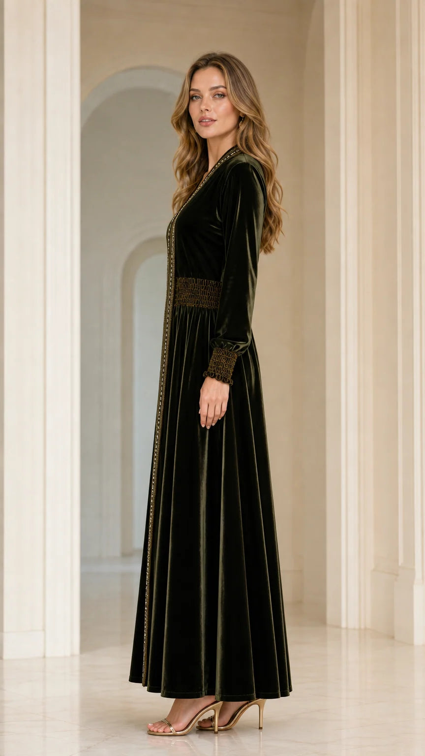 Side profile view of model in Dark Green velvet kaftan dress with smocked waist