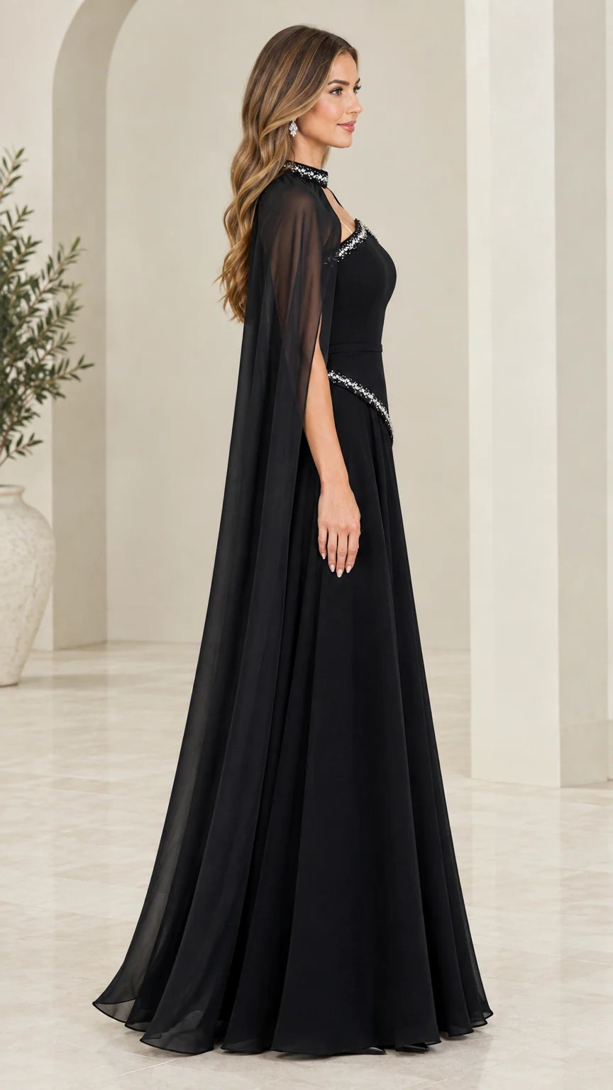 Side profile view of black evening gown showing dramatic sheer chiffon cape drape