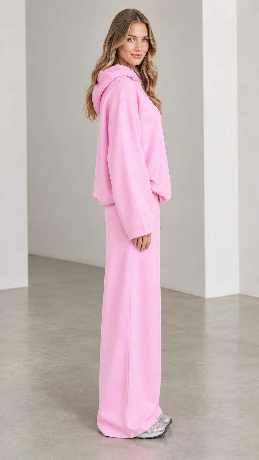 Side profile view of woman wearing Light Pink matching hoodie and wide leg sweatpants