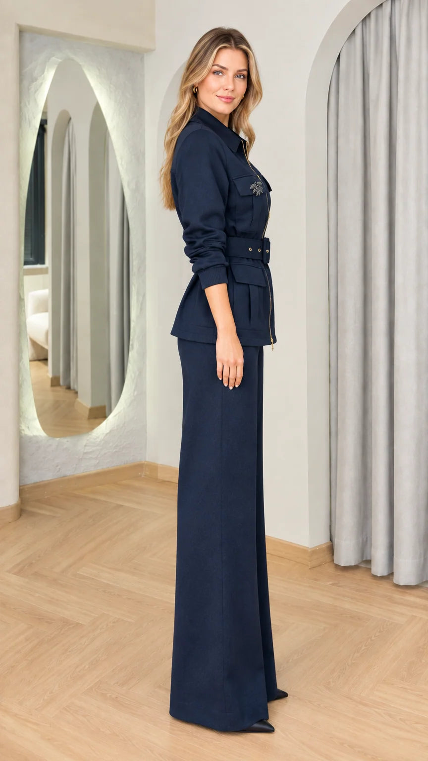 Side profile of woman in navy blue two-piece utility jacket and wide-leg pant set