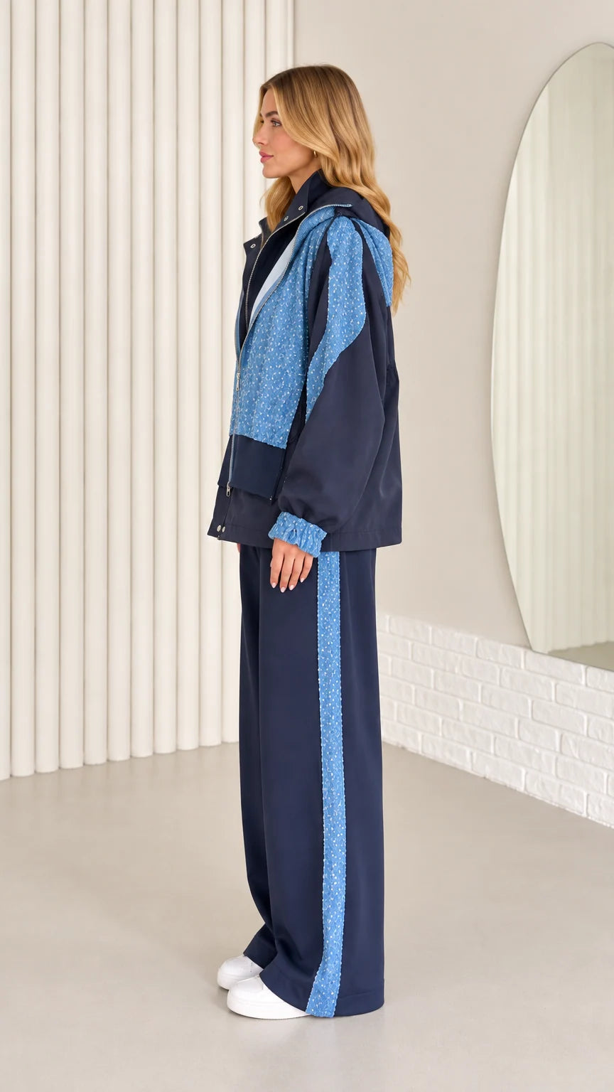 Side profile view of navy blue tracksuit set with sequin side stripe
