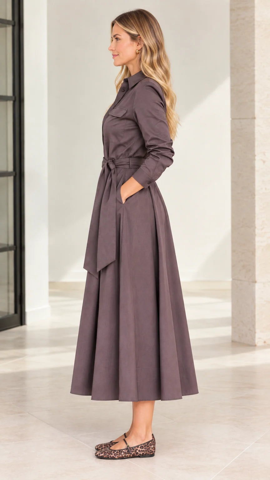 Side profile view of model wearing mocha brown belted midi shirt dress with pockets