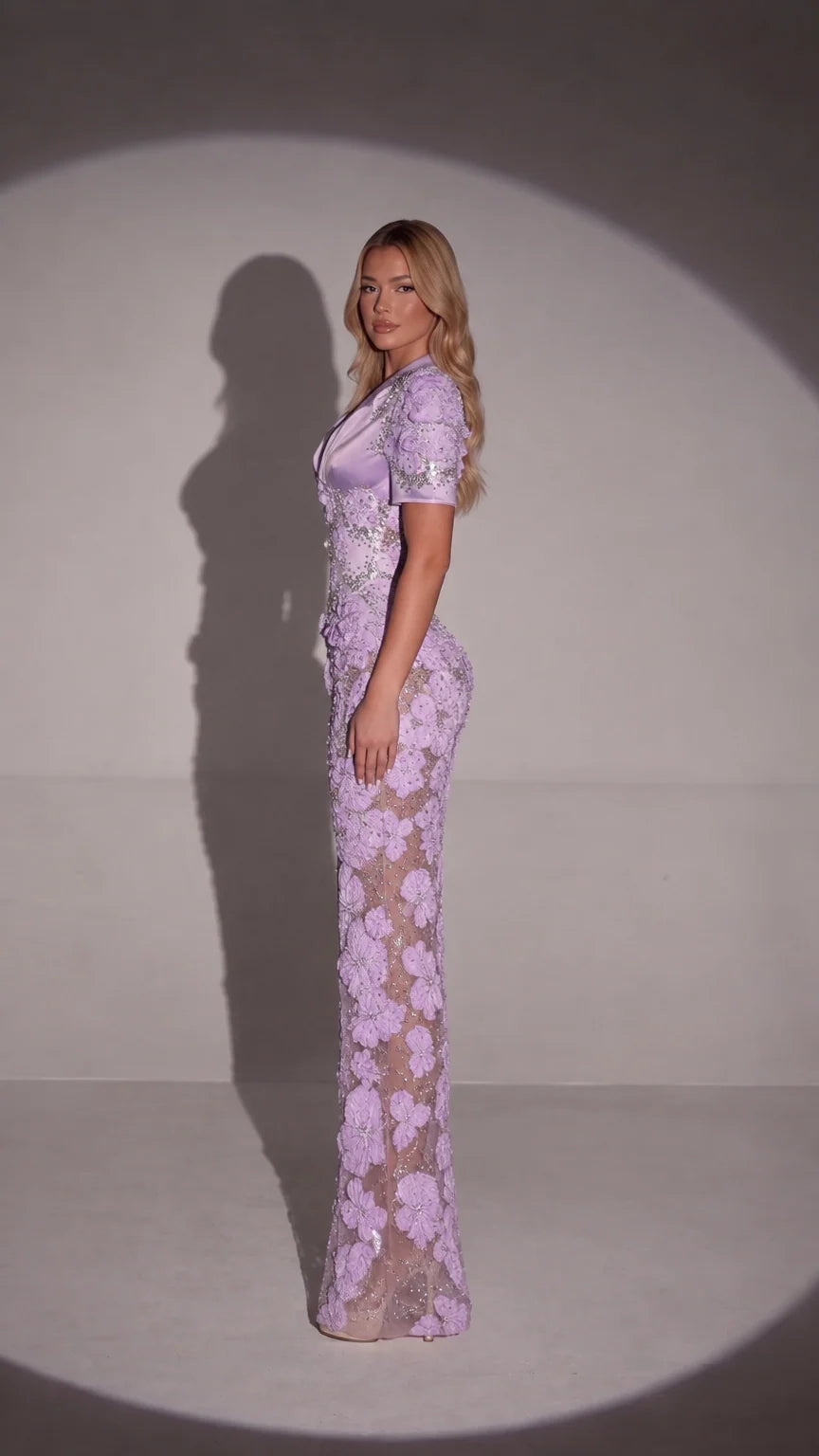 Side profile of model wearing lavender floral appliqué maxi dress