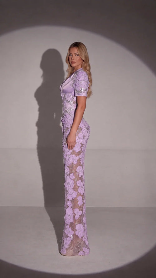 Side profile of model wearing lavender floral appliqué maxi dress