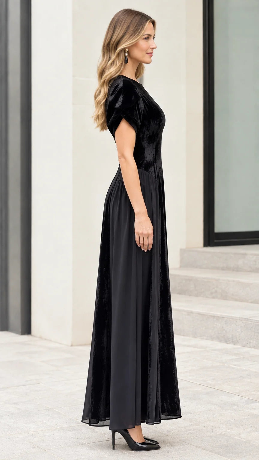 Side profile view of model wearing black velvet formal maxi gown