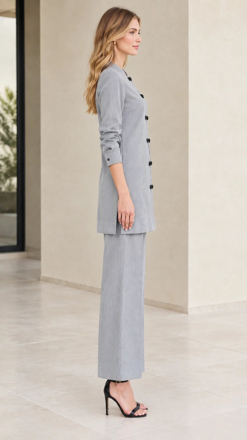 Side full-length view of woman wearing Light Grey tunic top and pants set