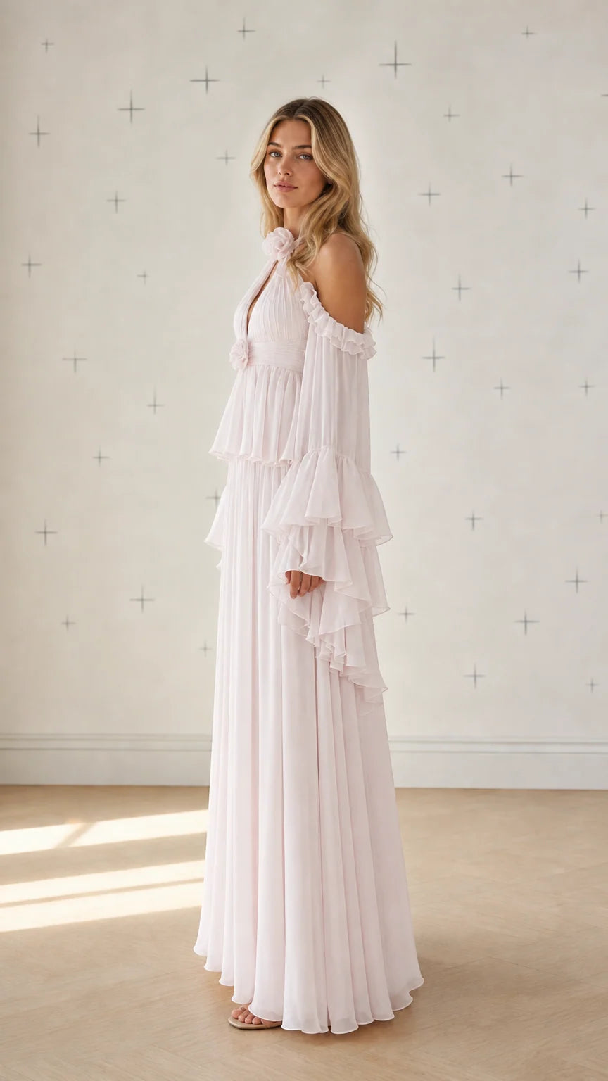 Side profile view of pink pleated maxi dress with ruffle sleeves