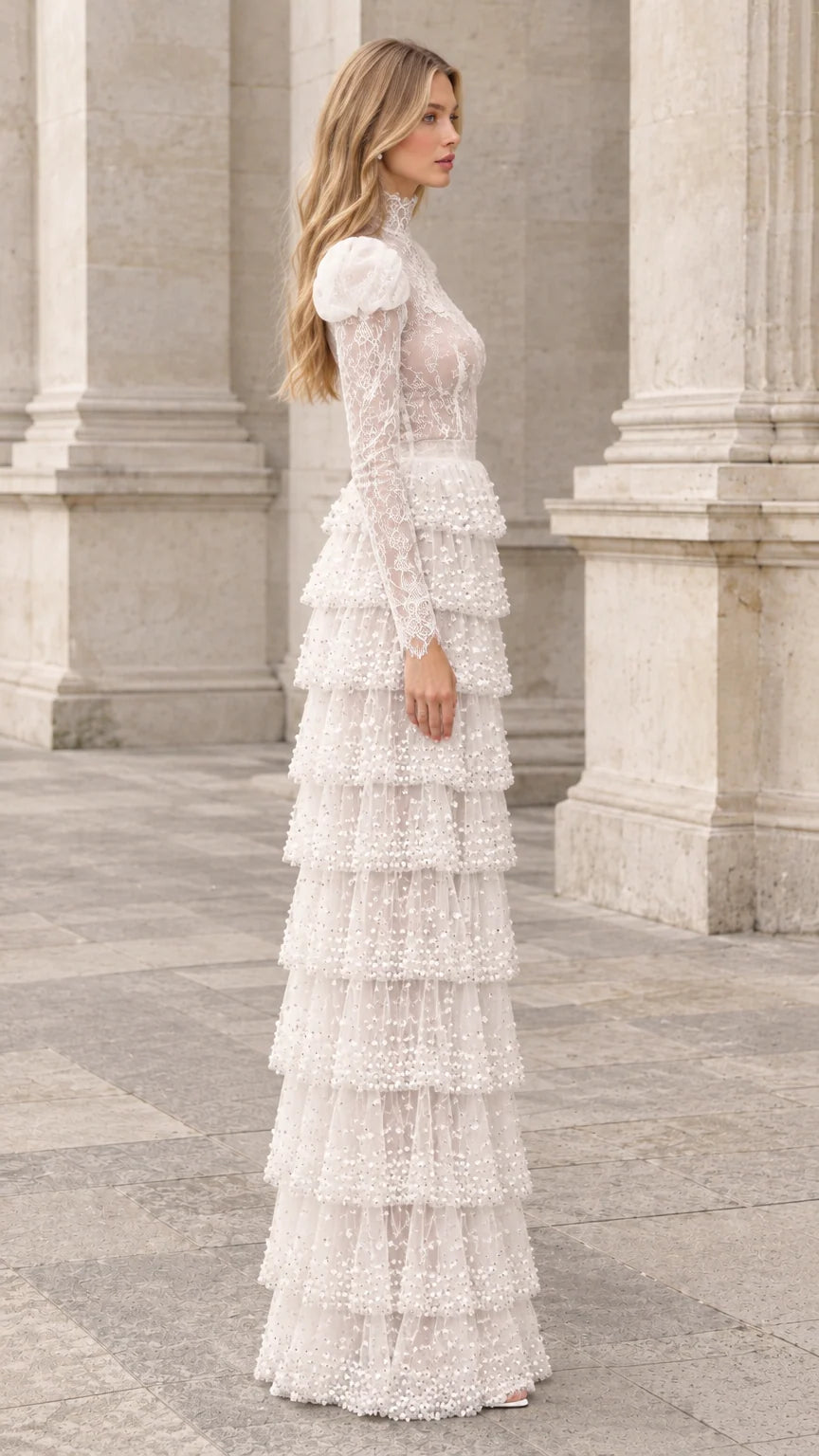 Side profile view of ivory tiered lace maxi gown showing sleeve and skirt drape