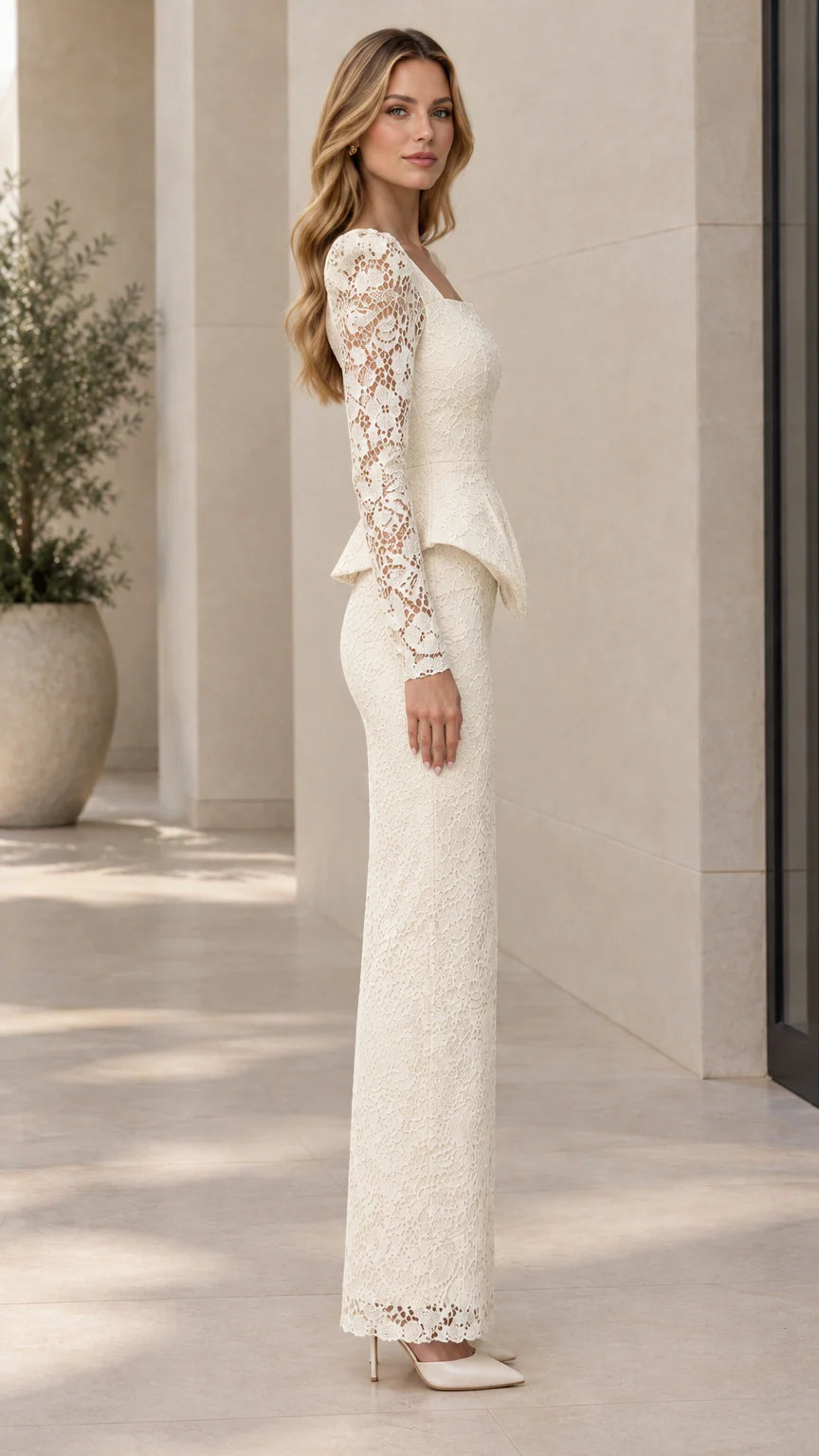 Side profile view of ivory long sleeve lace column maxi gown