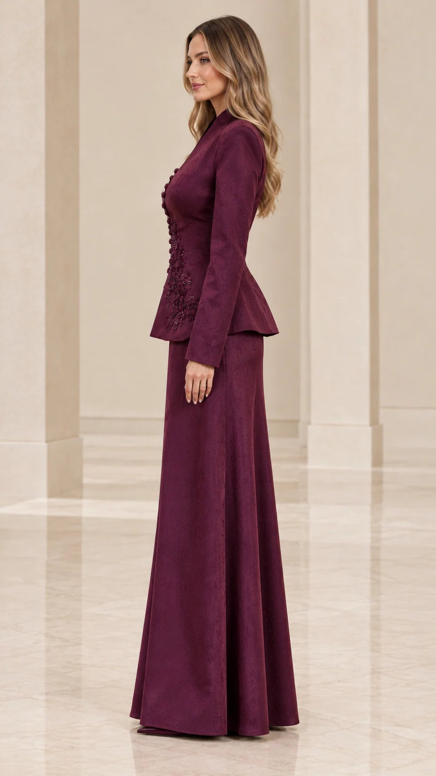 Side profile view of burgundy embroidered two-piece evening skirt suit