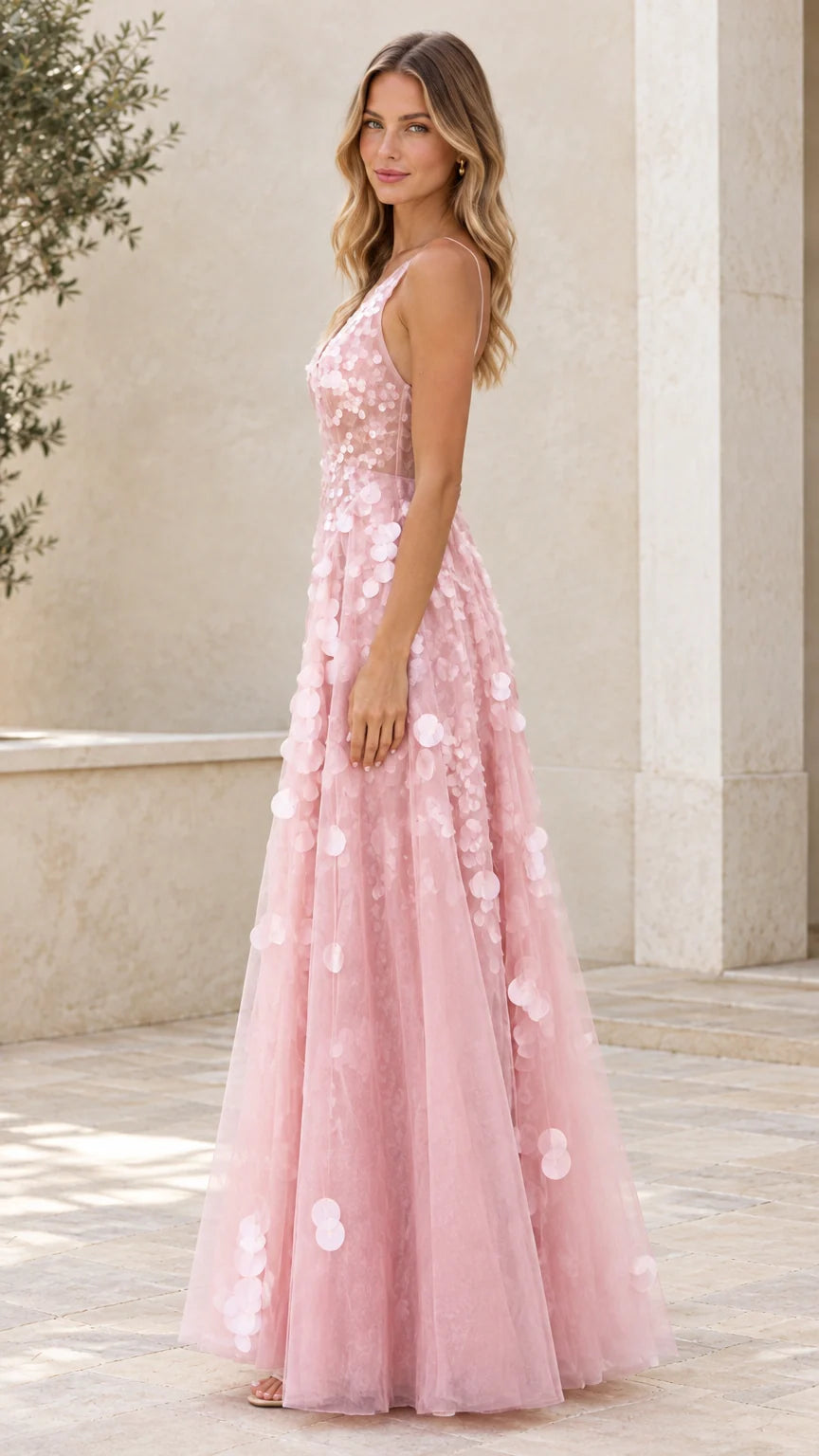 Side view of blush pink A-line tulle formal maxi dress with petal accents