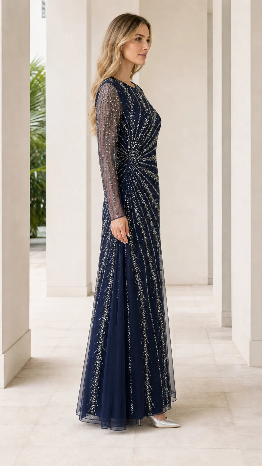 Side view of woman in navy blue floor-length embellished evening dress