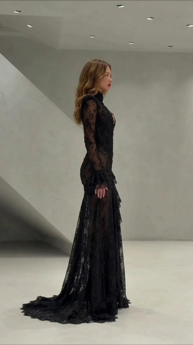 Side profile view of black long sleeve lace mermaid formal dress