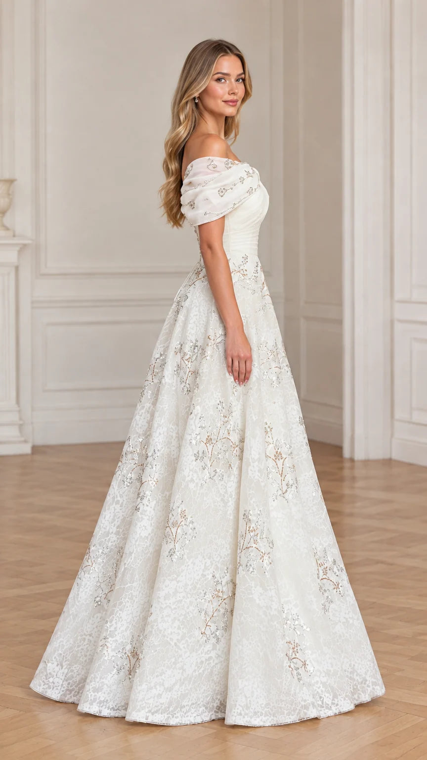 Side profile of model wearing ivory formal lace gown with ruched bodice