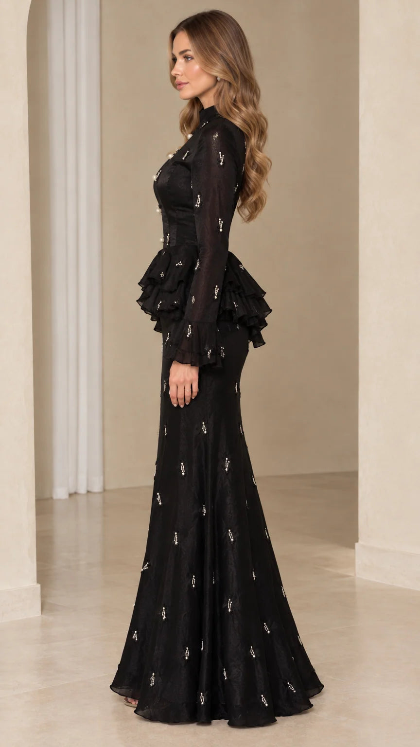 Side profile view of model wearing black long-sleeve peplum evening dress