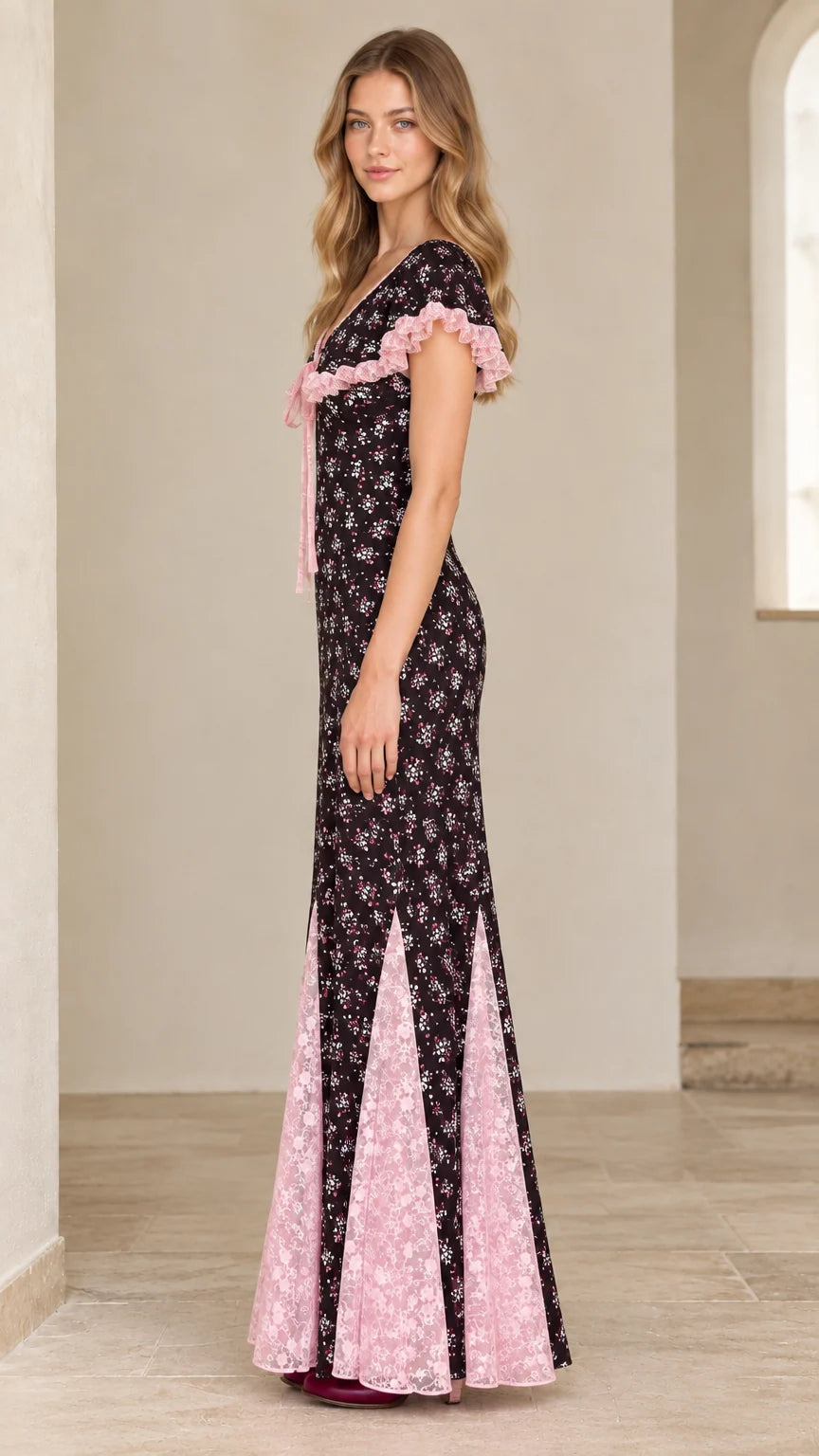 Side profile view of black floral godet maxi dress showing lace trim