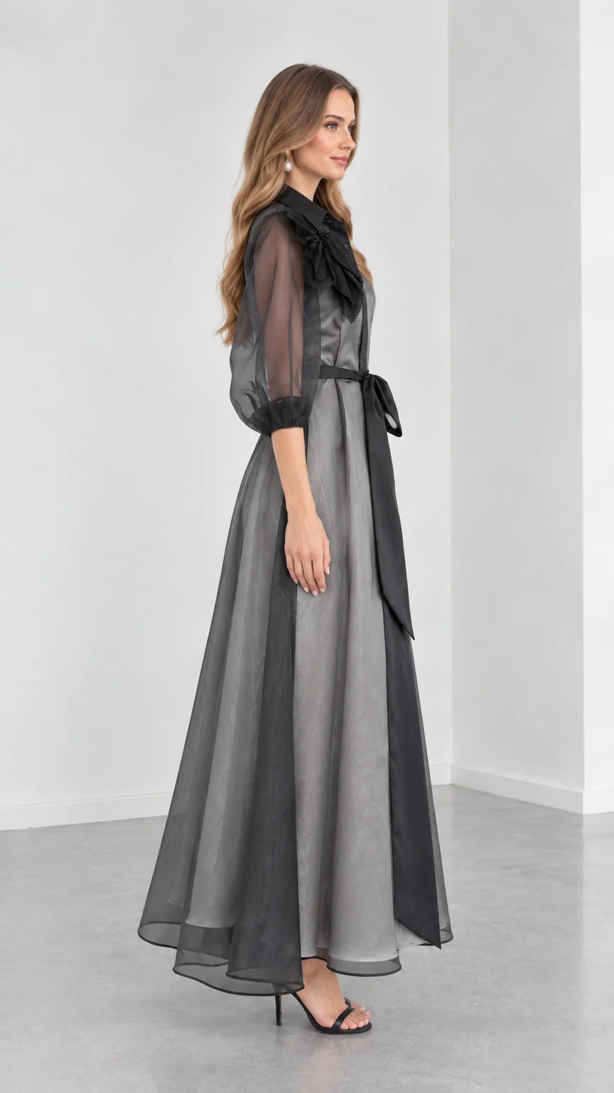 Side profile view of Charcoal Grey organza evening gown with sheer puff sleeves