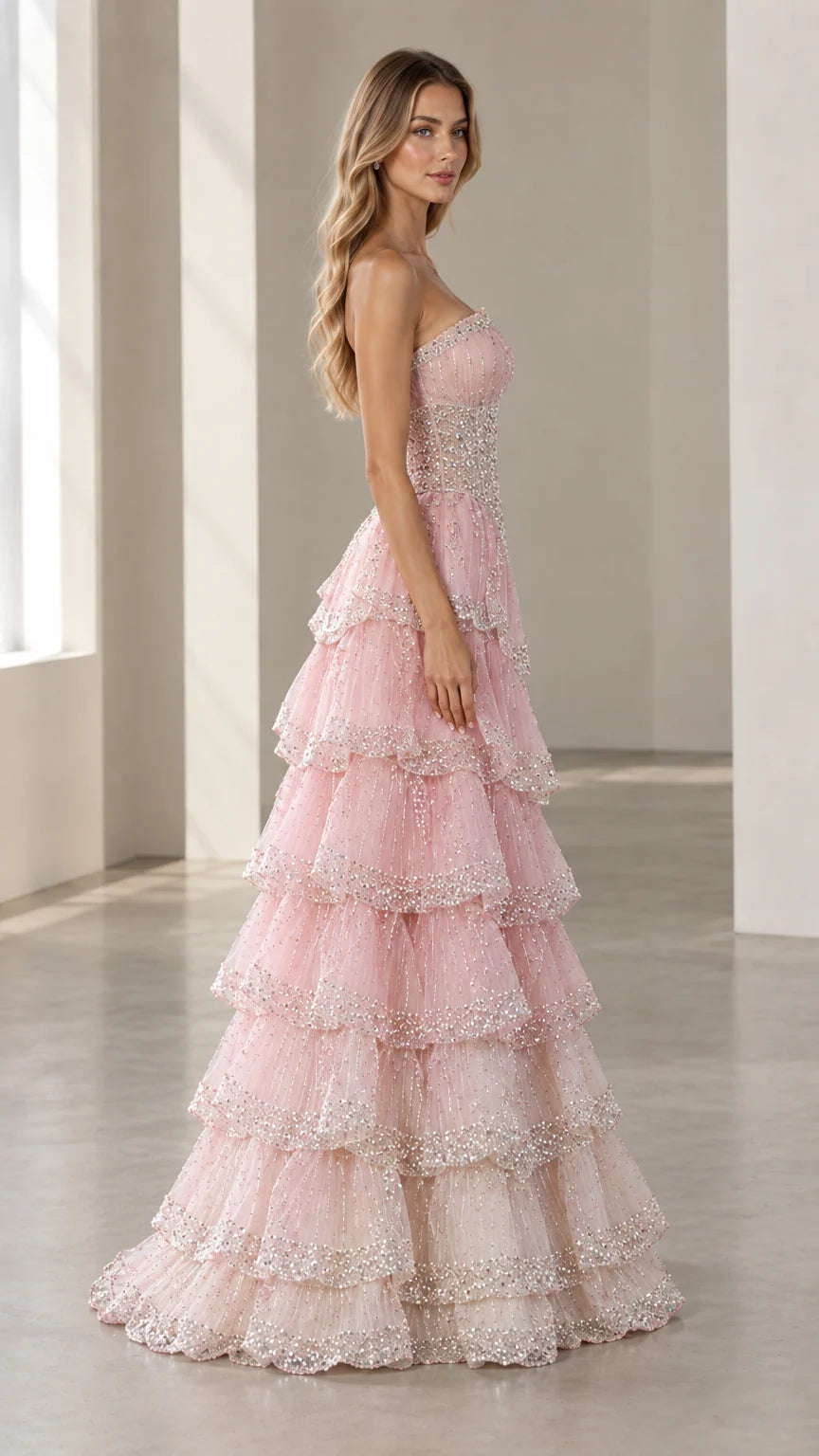 Side profile view of the Blush Pink strapless beaded tiered formal ballgown