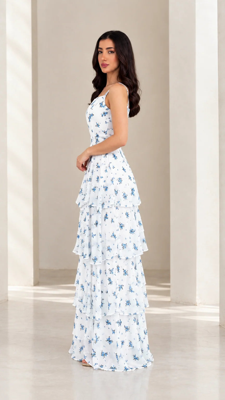 Side view of model in white floral tiered ruffle maxi dress