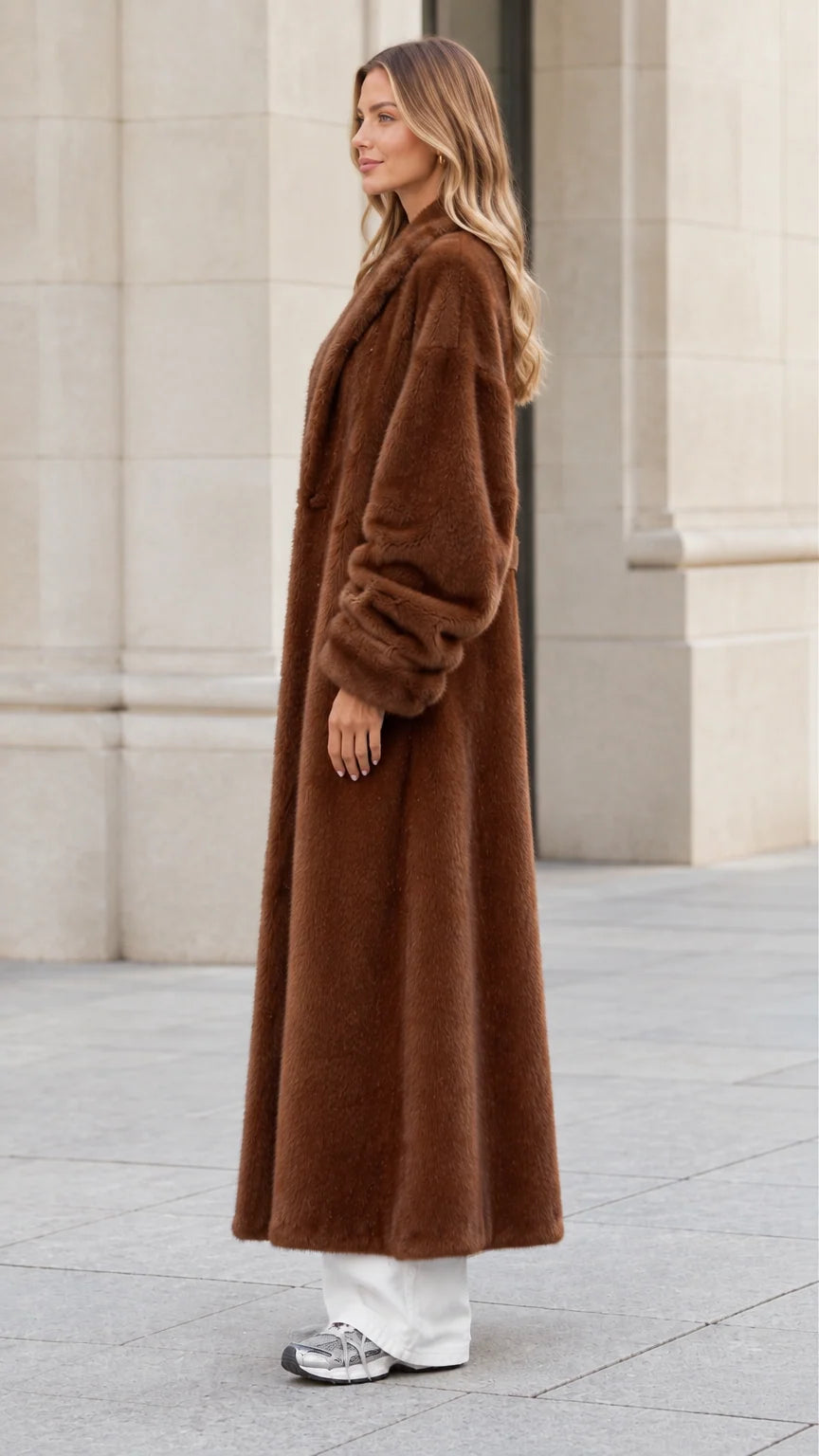 Side profile view of woman modeling chocolate brown maxi faux fur coat