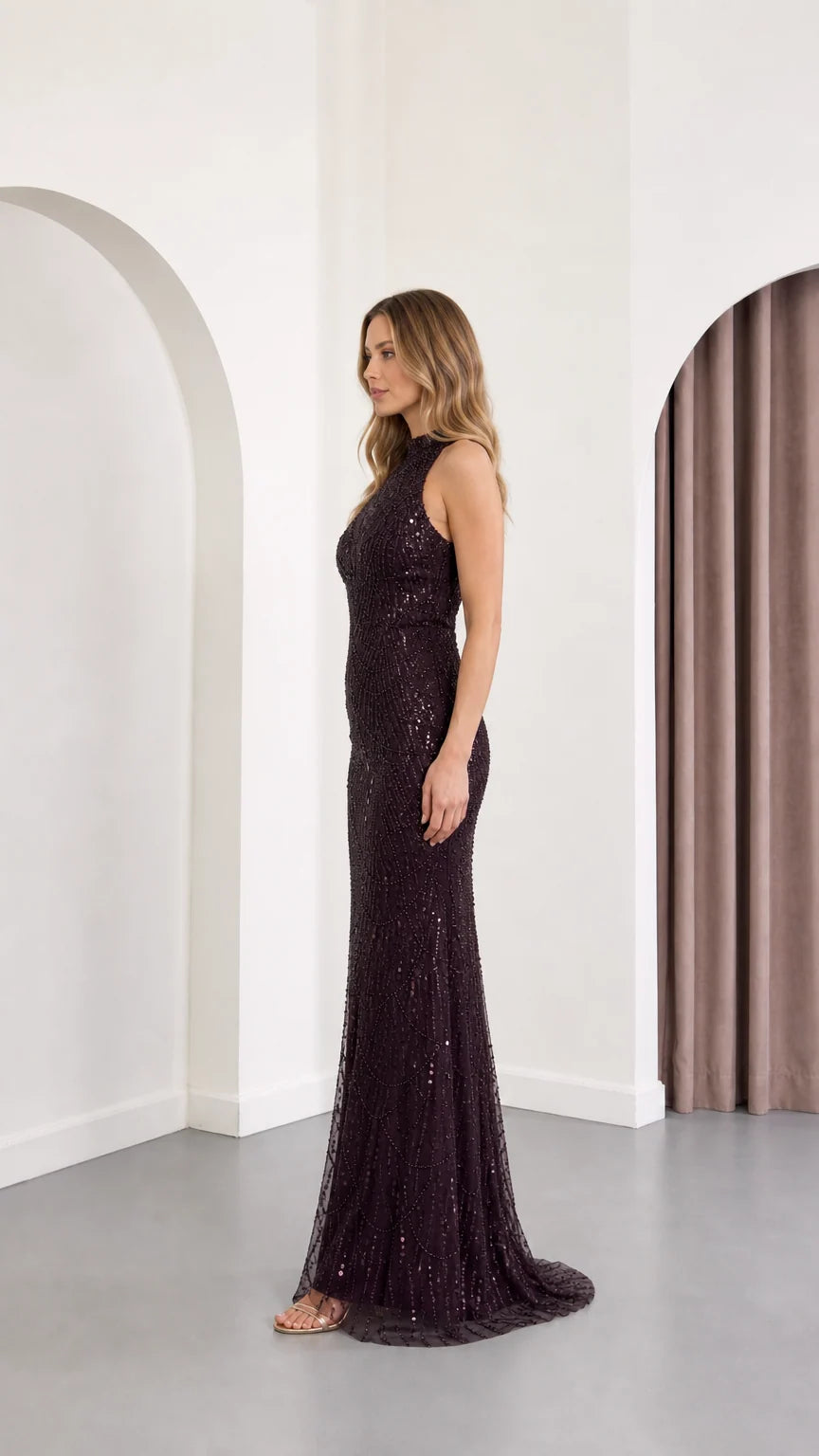 Side profile view of plum sequin high neck floor-length dress