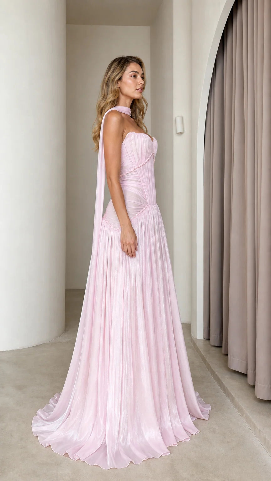 Side profile of pink pleated maxi dress with draping scarf