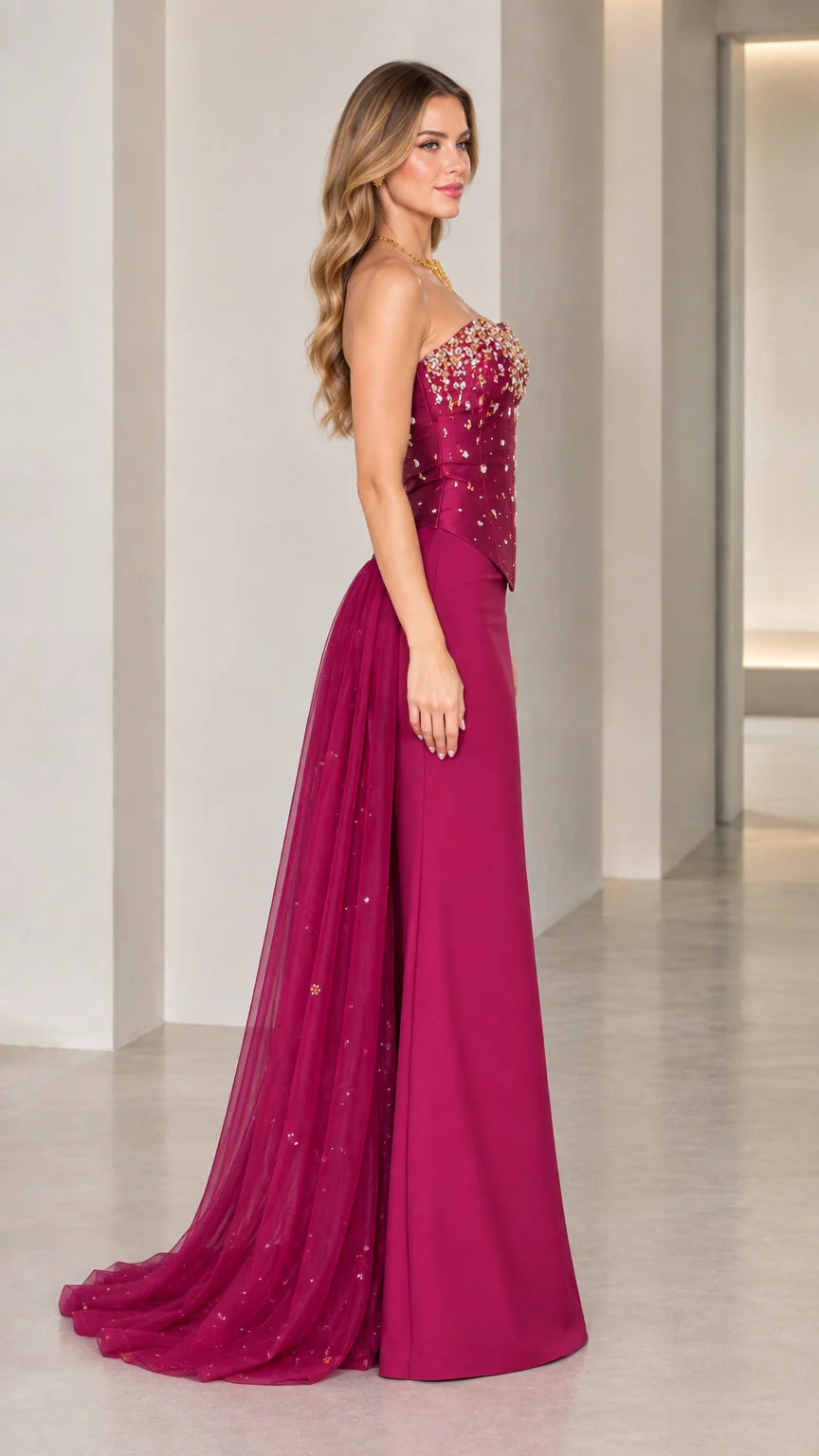 Side profile of model in magenta strapless formal gown showing floor-length train