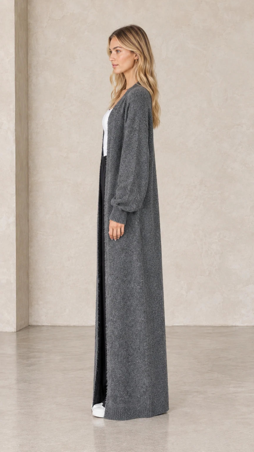 Side profile view of charcoal grey floor-length open front knit cardigan