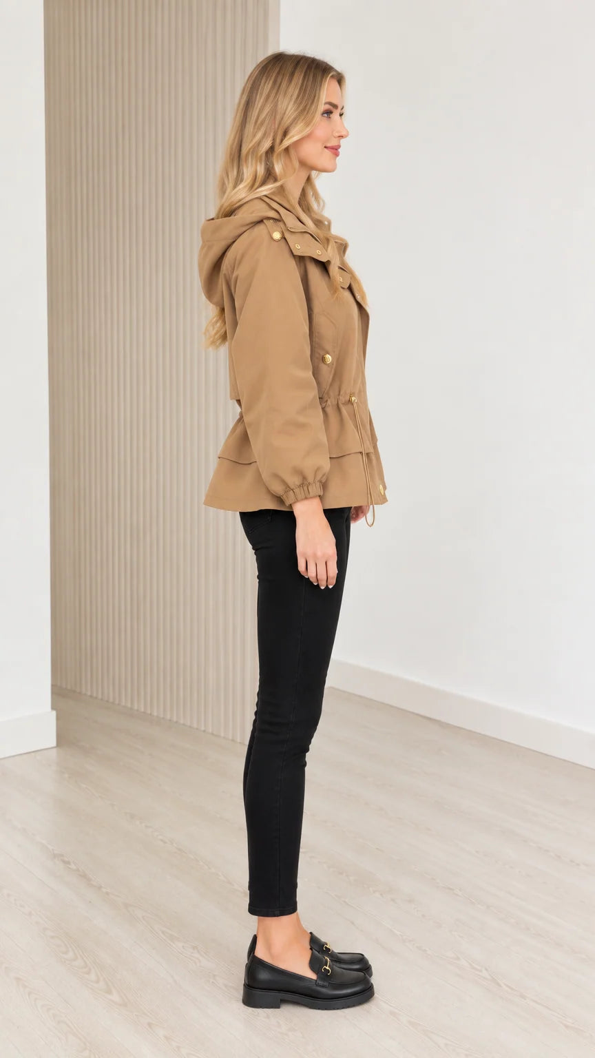 Side profile view of model wearing camel drawstring waist utility jacket