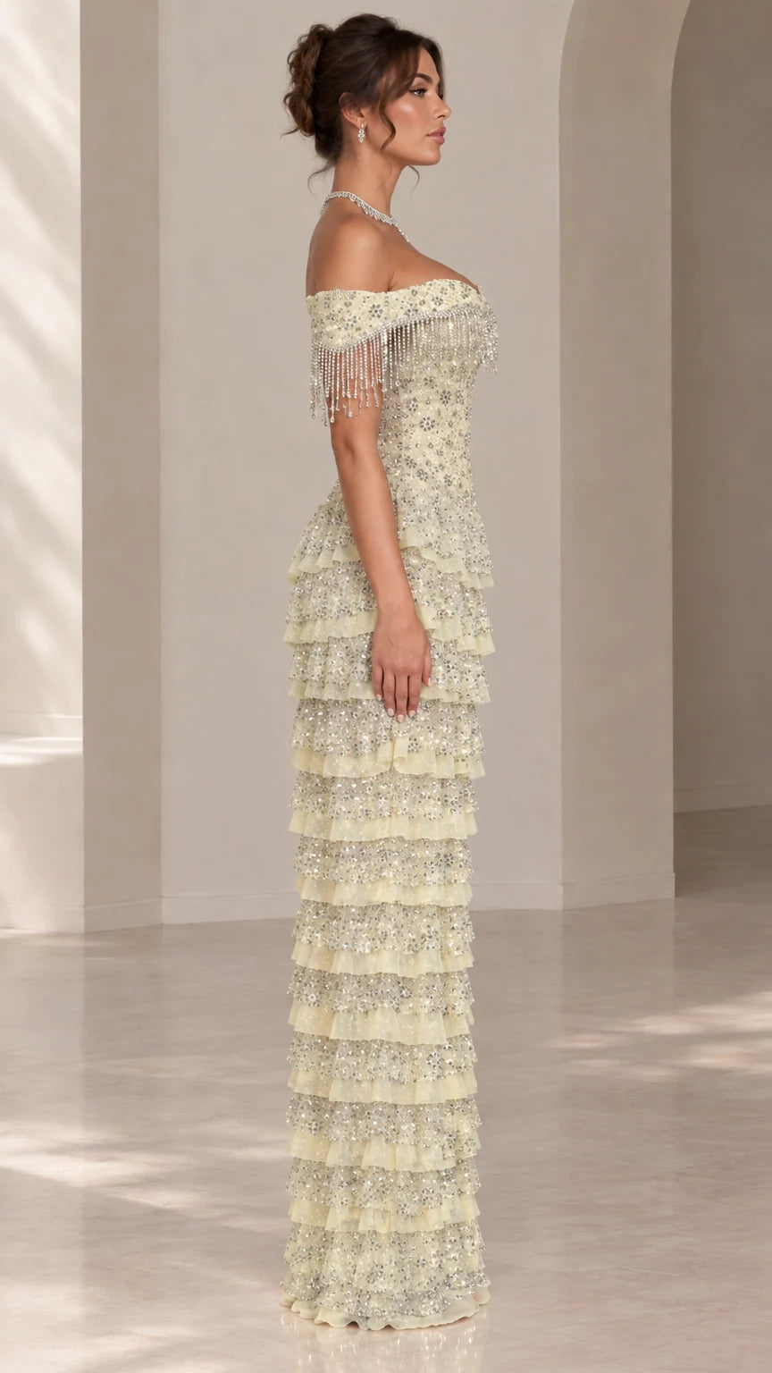 Side profile view of light yellow tiered sequin maxi formal dress