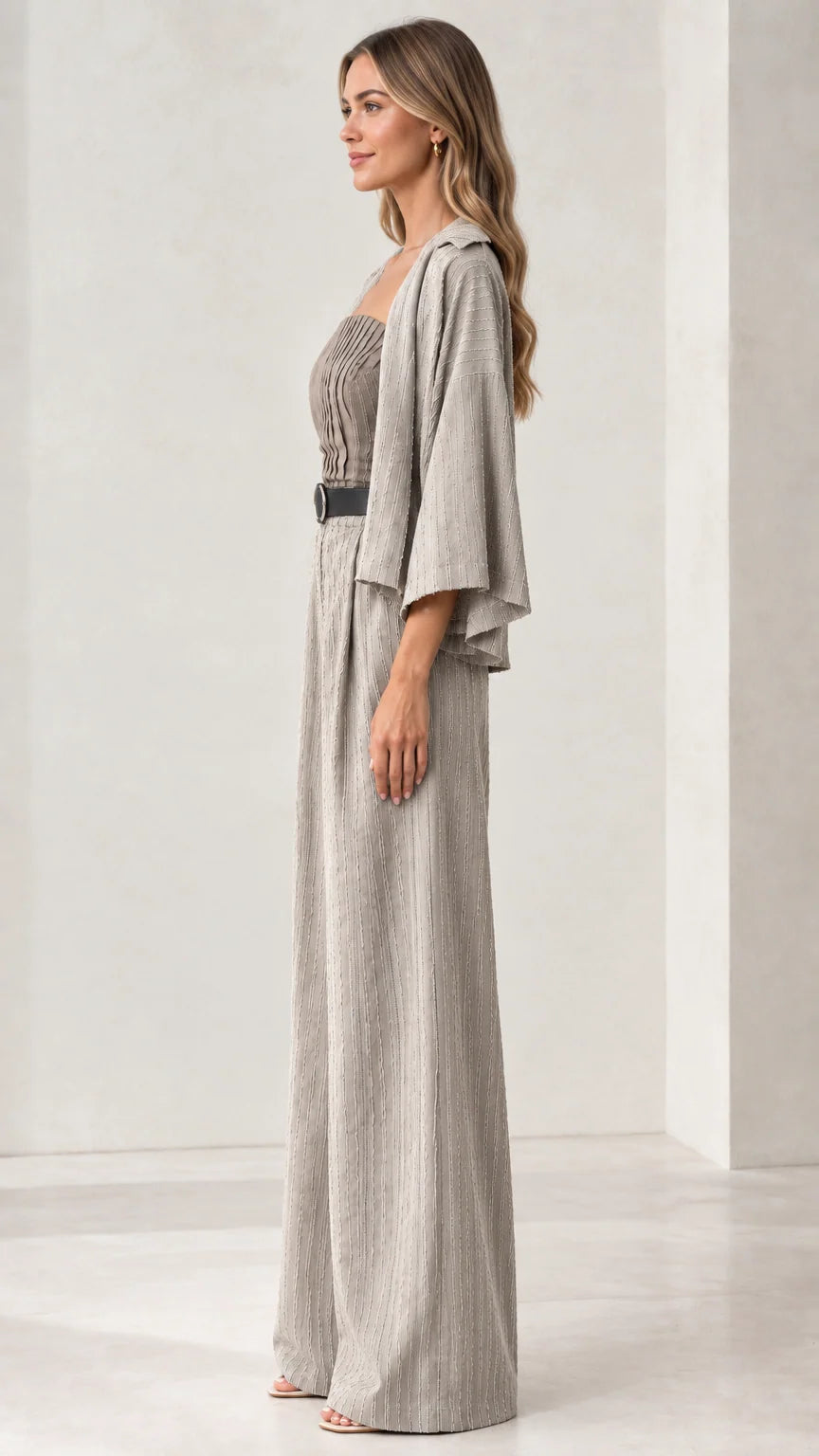Side profile of woman wearing light grey pleated wide-leg jumpsuit set