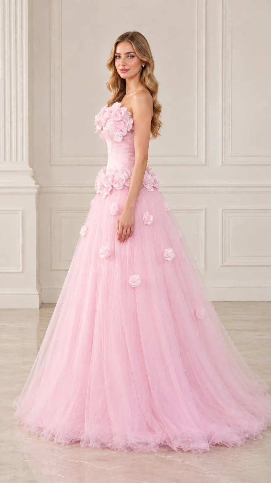 Side angle view of model posing in blush pink floral appliqué tulle evening dress