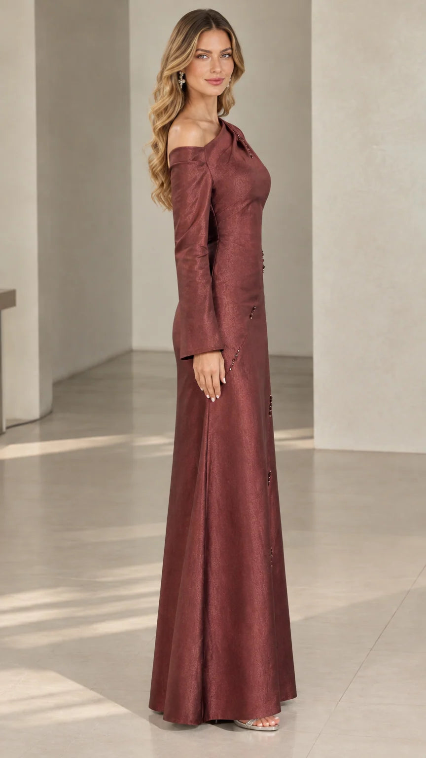 Side profile of burgundy one-shoulder formal floor-length dress
