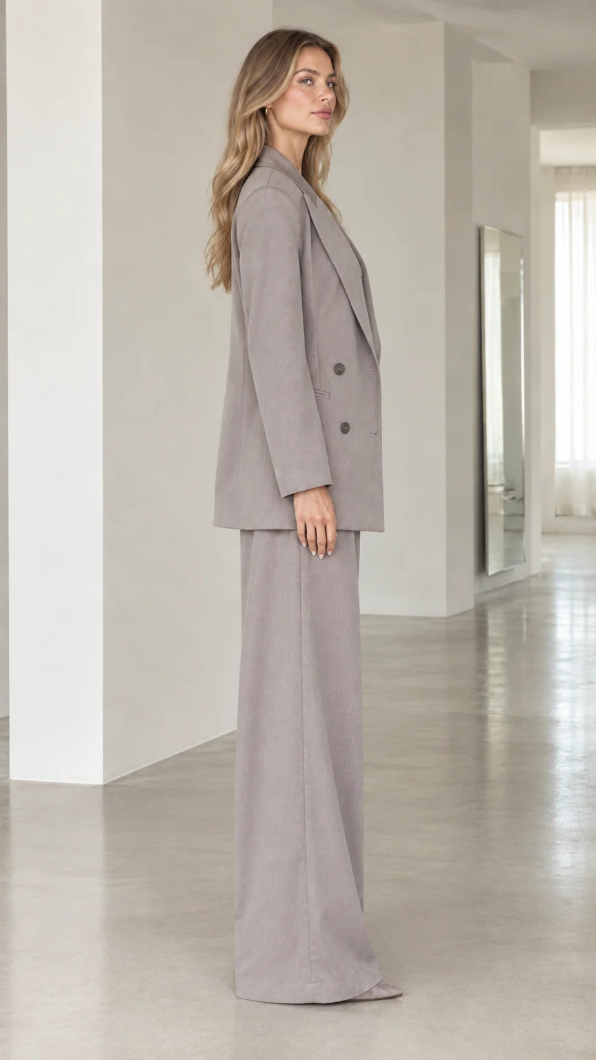 Side profile view of taupe grey 3-piece suit set showing relaxed tailored drape