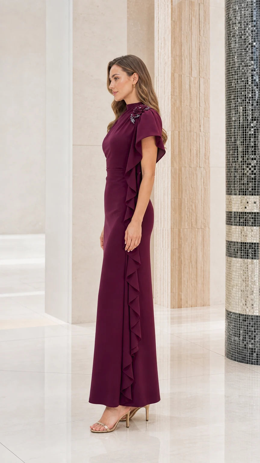 Side profile view of woman modeling the burgundy asymmetrical ruffle evening gown