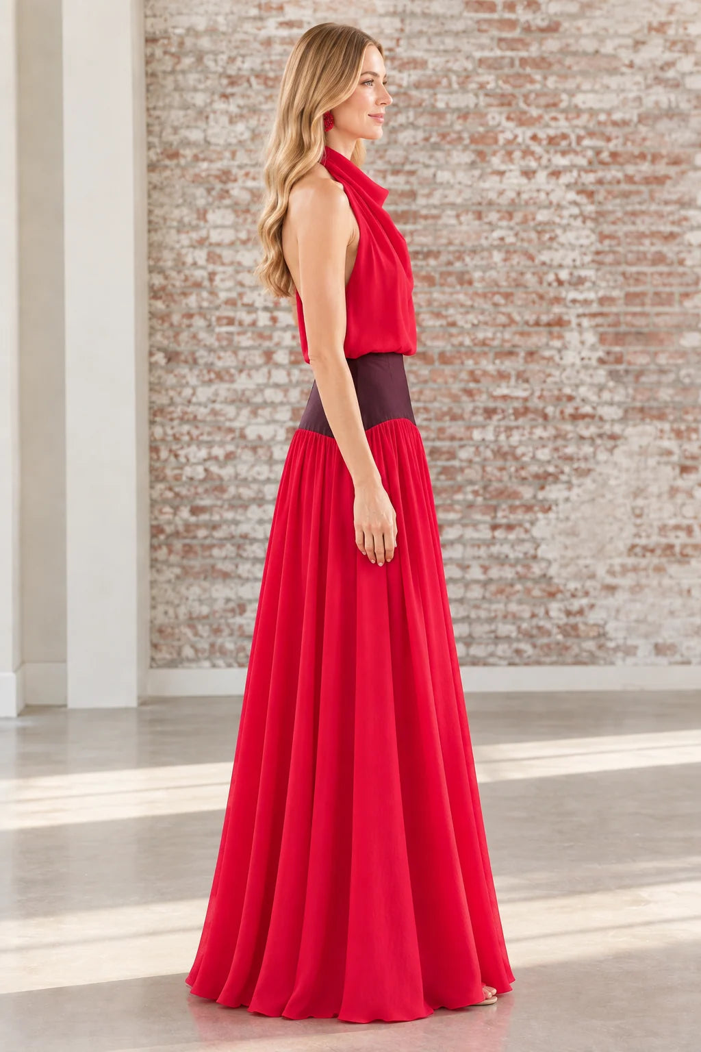 Side profile view of the red backless halter gown showing waist detail
