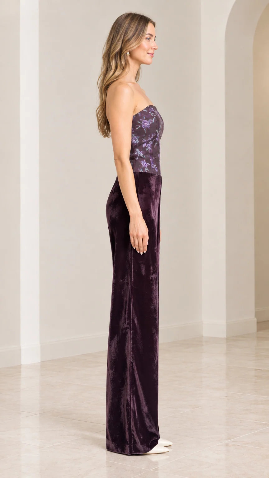 Side profile of woman in strapless plum purple velvet jumpsuit