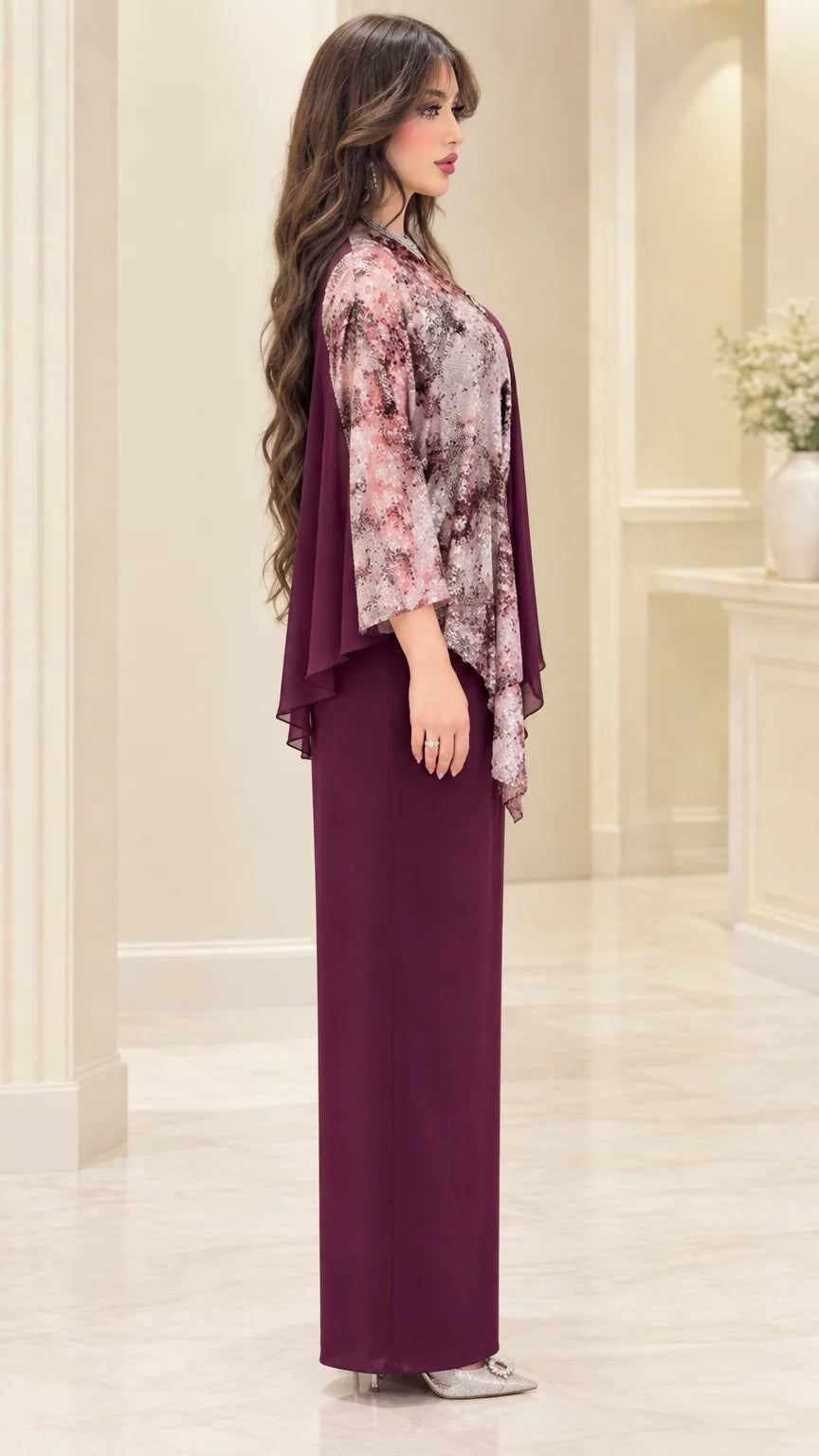 Side profile of burgundy cape overlay evening gown