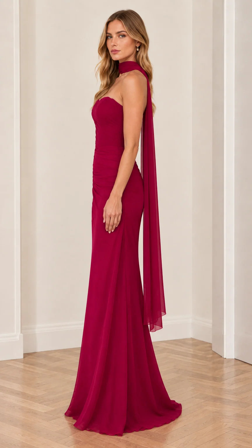 Side angle of berry red strapless evening dress showing draped silhouette