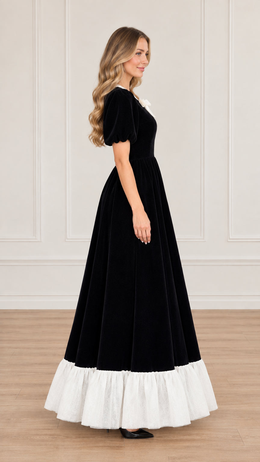 Side profile of woman wearing black vintage velvet maxi dress with puff sleeves