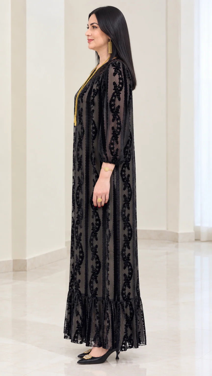 Side profile of black velvet burnout long sleeve maxi dress