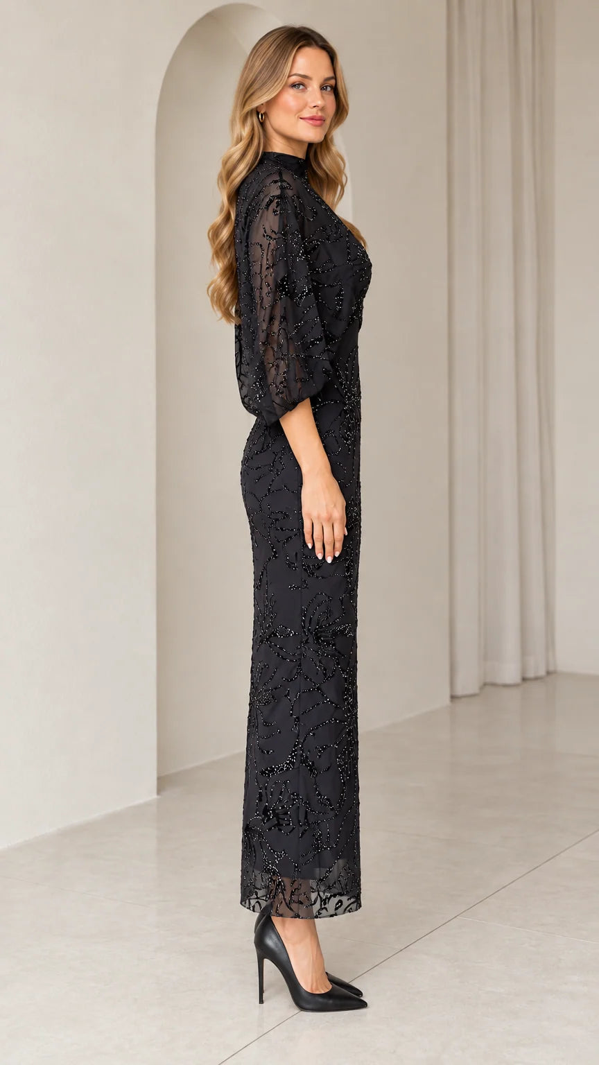 Side profile view of black beaded maxi dress showing column silhouette