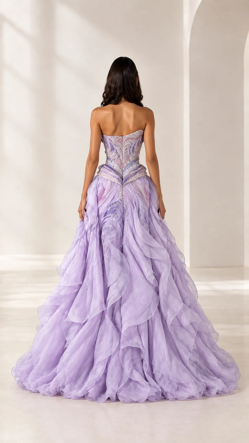 Back view of model in lavender sculpted bodice ball gown with cascading ruffles
